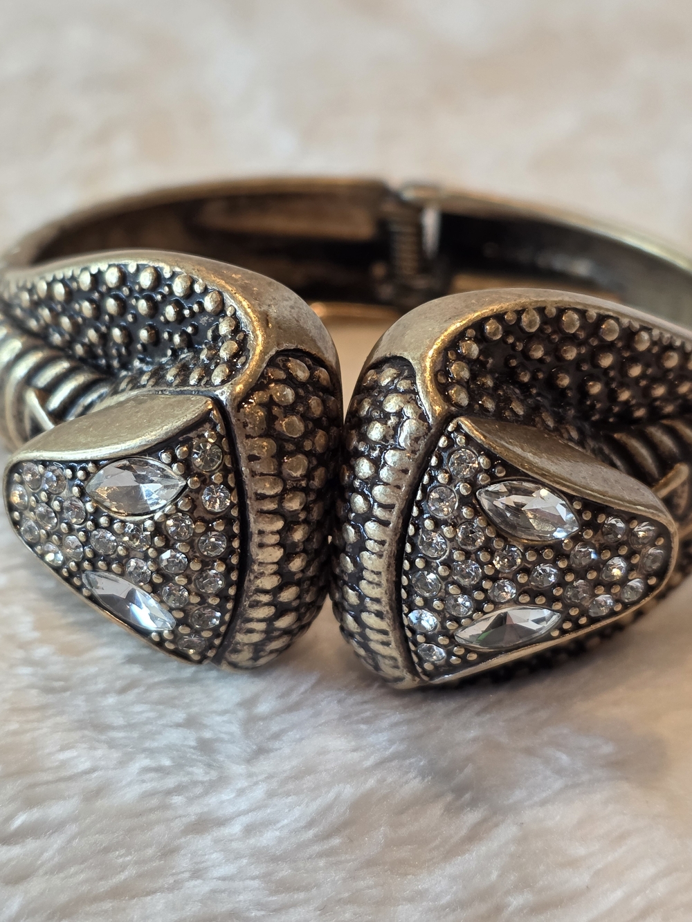 Costume jewelry bracelet featuring two detailed snake heads